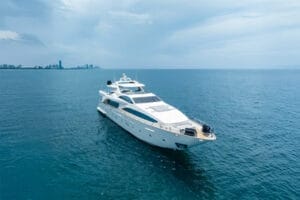 Luxury yacht cruising in open waters near Miami, offering exclusive superyacht rentals and serene ocean views on a sunny day.