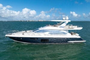 Luxury yacht sailing on clear blue waters under a partly cloudy sky in Miami, offering exclusive rental and charter experiences.