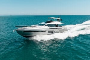 A luxurious superyacht cruising through the clear blue waters of Miami, showcasing modern design and elegance under a sunny sky, perfect for exclusive yacht charters and rentals.