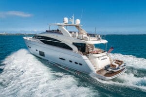 A luxurious superyacht cruising through clear blue waters in Miami, showcasing an elegant deck and a sleek white design. Perfect for exclusive yacht charters and rentals.