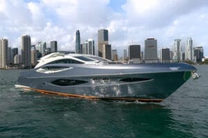 Luxury yacht cruising in front of Miami skyline, showcasing elegant design and premium yacht charter experience.