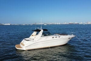 Luxury yacht floating on the blue waters of Miami with city skyline in the background, ideal for island-hopping and day cruises with Wonder Yachting.