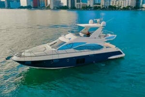 Luxury yacht cruising in Miami waters with city skyline in the background, ideal for island-hopping and day cruises. Wonder Yachting offers premier Miami yacht rentals.