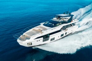 A luxury superyacht cruising through the clear blue waters of Miami, offering exclusive yacht charters and rentals.