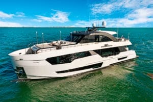 Luxurious white superyacht cruising on clear blue waters under a bright sky in Miami, showcasing exclusive yacht charters and premium superyacht rentals.